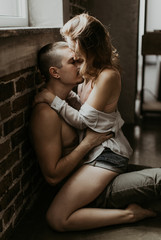 Obraz na płótnie Canvas beautiful loving couple kissing in the kitchen