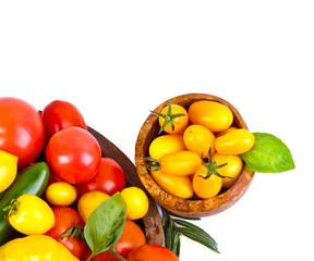 Assorted tomatoes and vegetables isolated on white background. Photo for your design.