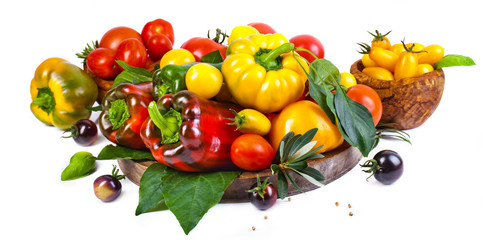 Assorted tomatoes and vegetables isolated on white background. Photo for your design.