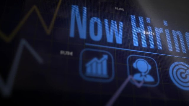 A Now Hiring business concept on a flashing computer monitor with moving graphs and data.