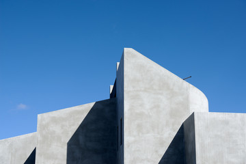 Detail of geometric shapes and clean lines of a modern Australian concrete domestic house shown by the play of sun and shadow. 