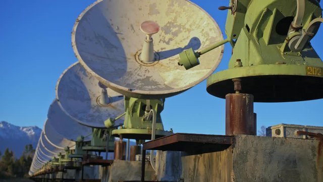 Woman student operator of institute of Solar Terrestrial Physics monitors communication equipment in notebook. Unique array solar radio telescope. Sun Solar Radio Telescope. The 'Quasar' observatory