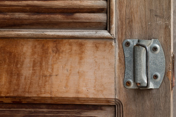 Metal old rusty handle on wooden door