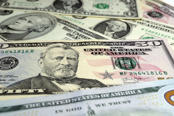 Dollar bills of different value on the surface close up Selective focus