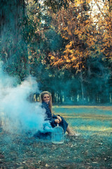 Attractive woman with a colorful smoke grenade bomb fashion