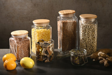 Sustainable lifestyle concept, zero waste, cereals and beas in glass, eco friendly, plastic free items. Dark background.