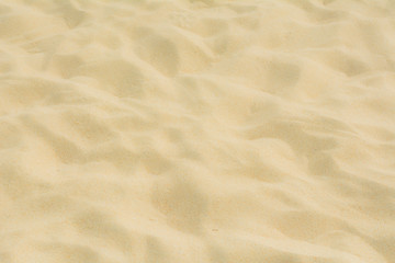 Naklejka na ściany i meble Texture of beach sand as background.
