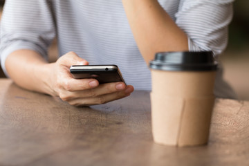Hands of a woman using a mobile cell phone