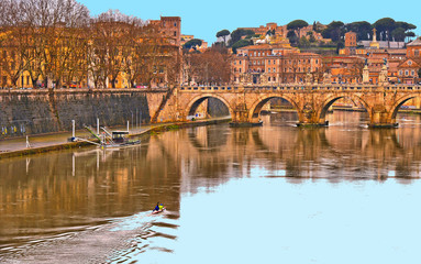 cityscape and panoramic view of old bridge with blue sky water reflections and dome of St. Peters cathedral church with old buildings and architecture in Rome, Italy