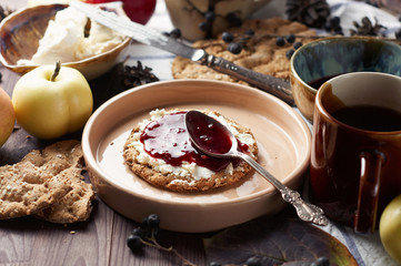 Swedish rye crispbread with cream cheese and raspberry jam. Autumn and winter breakfast concept.