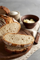 Artisan sliced toast bread with butter and sugar on wooden cutting board
