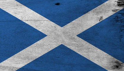 Fototapeta na wymiar Flag of Scotland on wooden plate background. Grunge Scotland flag texture, it is a blue field with a white diagonal cross that extends to the corners.