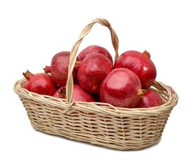 Pomegranates in basket on white background including clipping path