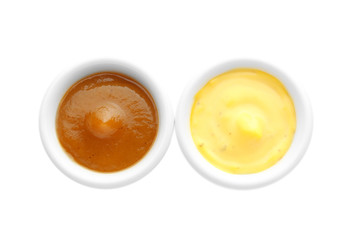 Different tasty sauces in bowls on white background