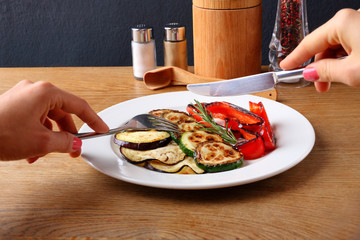 Stock Photo -  Roasted bell peppers and eggplant on a white plate.