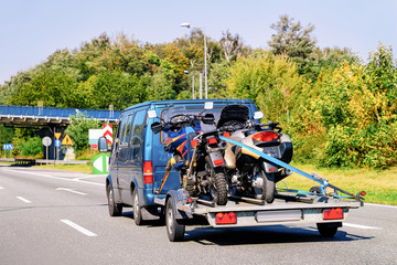 Mini van with motorcycles on trailer in Road Slovenia