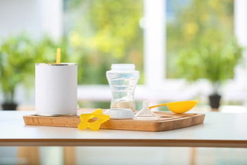 Feeding bottle with powder on wooden board