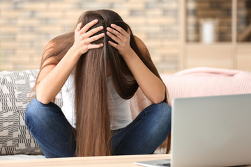 Woman suffering from headache at home