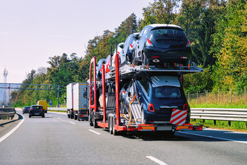 Naklejka premium Cars carrier truck on asphalt highway road in Poland