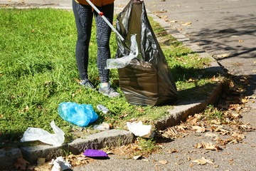 Woman gathering trash in park