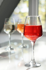 Glass of tasty wine on table