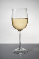 Glass of expensive white wine on table