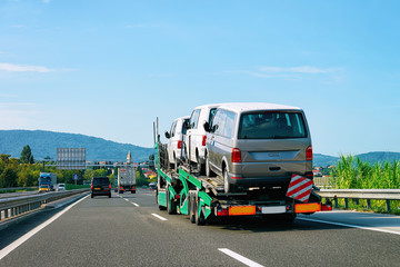 Naklejka premium Truck carrier with mini vans in road in Slovenia