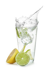 Glass of water with lemon, lime and mint on white background