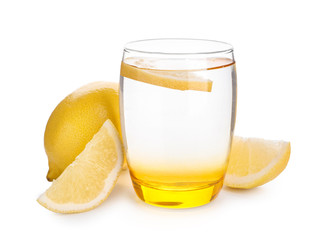 Glass of water with lemon on white background