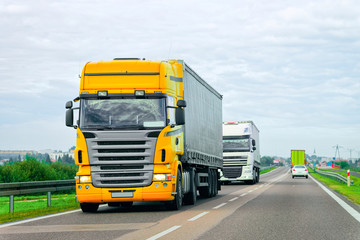 Fototapeta na wymiar Yellow Truck at asphalt road of Poland
