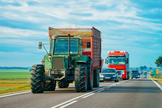 Fototapeta Agricultural tractor at highway road in Poland