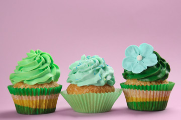 Tasty cupcakes on color background