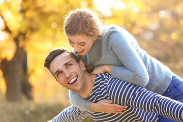 Fototapeta premium Happy young couple having fun in autumn park