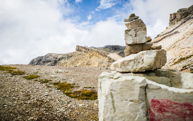 Fototapeta premium The Lagazuoi lodge, with a pile of stones in the foreground, Cortina d'Ampezzo, Dolomites, Italy.