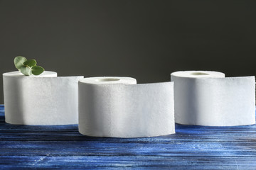 Rolls of soft toilet paper on wooden table