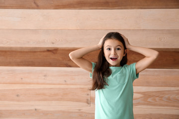 Emotional girl on wooden background
