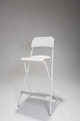 Fototapeta premium Empty white chair in photographic studio