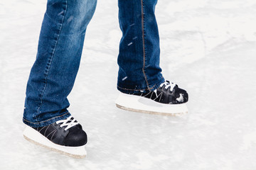 Legs in sports skates are rolled on ice
