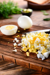 Cut boiled egg on wooden board, closeup