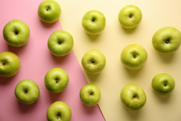 Ripe tasty apples on color background, top view