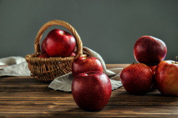 Ripe tasty apples on wooden table