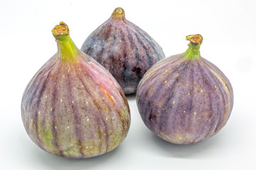 A group of three figs against a white background