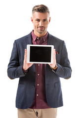 smiling stylish man in jacket showing digital tablet with blank screen isolated on white