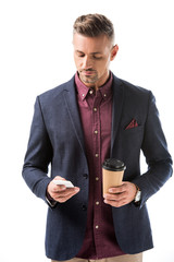 confident stylish man with paper coffee cup using smartphone isolated on white