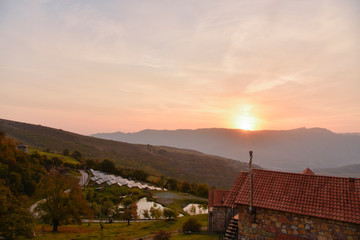 Mountain Landscape of Sontse rises in a mountain valley on the slope of the house and small outbuildings of Armenia