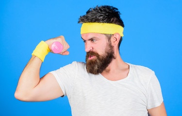 Sportsman retro outfit training blue background. Athlete training with cute dumbbell. Man bearded...