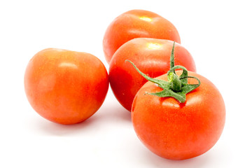 Ripe red tomatoes against a white background