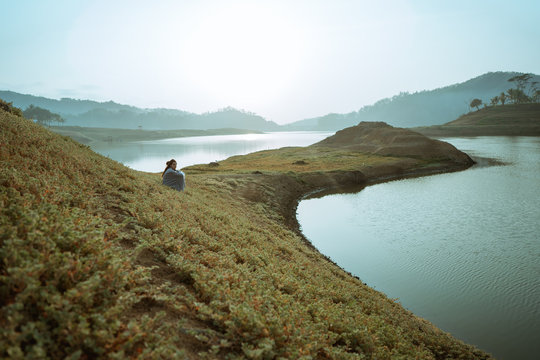 portrait alone women sitting with blangket  relax side the river