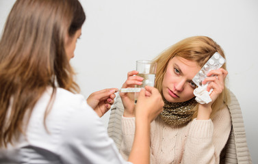 Cold and flu remedies. Doctor communicate with patient recommend treatment. Doctor ask patient about symptoms. Flu and cold treatment. Woman consult with doctor. Girl in scarf examined by doctor