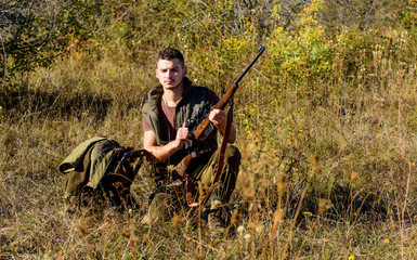 Hunting equipment concept. Hunter with rifle looking for animal. Hunter khaki clothes ready to hunt...